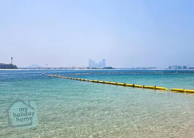 a long pier in the middle of the water at Steps to Beach - Resort Residence - Palm Jumeirah in Dubai