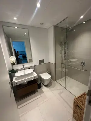 a bathroom with a toilet and a sink and a shower at Brand new apartment next to Burj Al Arb in Dubai