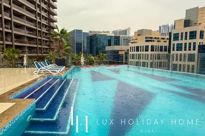 a large swimming pool on the roof of a building at LUX The Burj Khalifa Downtown View Studio 2 in Dubai