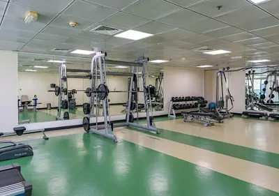 a fitness room with a gym with a swimming pool at 1BR Elegant Apartment in Marina Diamond 3 Metro Access in Dubai