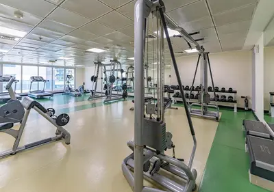 a gym with a row of tread machines at 1BR Elegant Apartment in Marina Diamond 3 Metro Access in Dubai