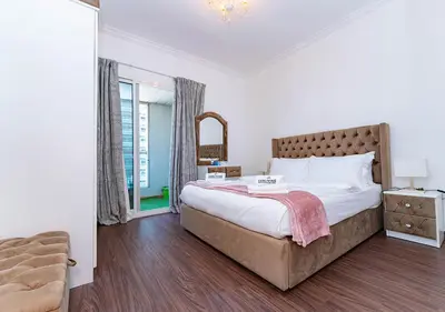 a bedroom with a large bed and a window at 1BR Elegant Apartment in Marina Diamond 3 Metro Access in Dubai