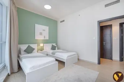 a white room with two beds and a window at Vogue Marina Torch Tower near JBR Beach and Dubai Marina Mall, Two Bedroom Apartment with Balcony and City Skyline View, Access to all Amenities in Dubai