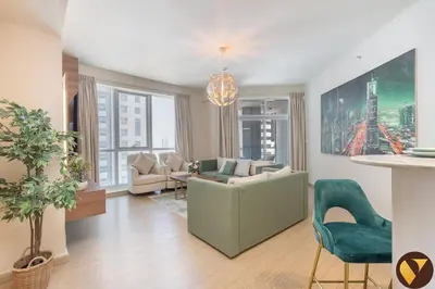 a living room with a green couch and chairs in it at Vogue Marina Torch Tower near JBR Beach and Dubai Marina Mall, Two Bedroom Apartment with Balcony and City Skyline View, Access to all Amenities in Dubai