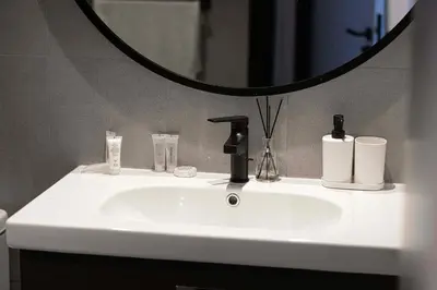 a white bathroom sink with a mirror above it at DVR 2BR in 15 Northside Business bay in Dubai