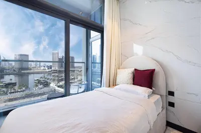 a bedroom with a white bed and a large window at DVR 2BR in 15 Northside Business bay in Dubai