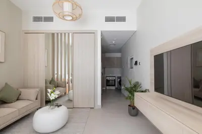 a living room with a couch and a table at Brand New Luxury Stays by Edora at Sway Residence Dubai Hills in Dubai