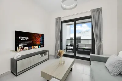 a living room with a tv and a couch at Brand New Luxury Stays by Edora at Sway Residence Dubai Hills in Dubai