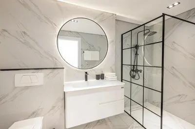 a bathroom with a sink and a mirror at Daniels 3BR with Palm View at Marina Pinnacle in Dubai
