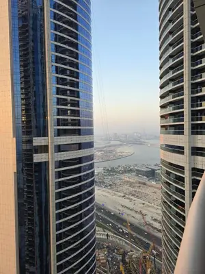 two tall skyscrapers in a city next to a river at 4905 Luxury View By Royal Sky Vacation Homes Paramount Tower A in Dubai