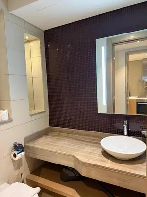 a bathroom with a sink and a mirror at 4905 Luxury View By Royal Sky Vacation Homes Paramount Tower A in Dubai