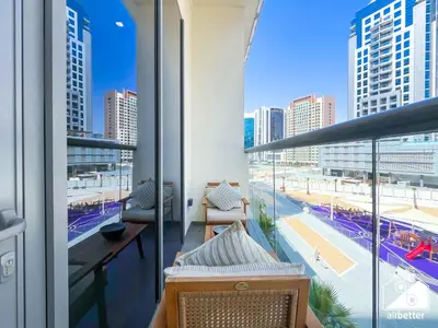 a balcony with a view of a city skyline at Luxury at Sterling East Studio with Park Views in Dubai