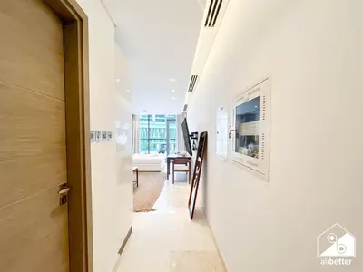 a hallway with a white wall and a door at Sterling East Prime Location ST in Business Bay in Dubai