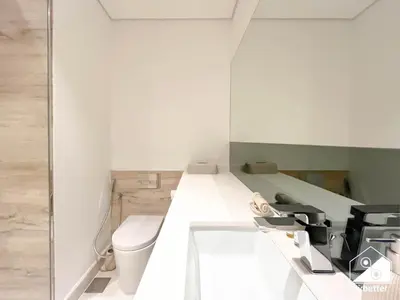 a bathroom with a toilet and a sink at Sterling East Prime Location ST in Business Bay in Dubai