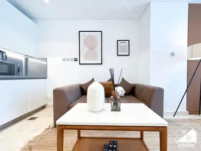 a living room with a couch and a table at Sterling East Prime Location ST in Business Bay in Dubai