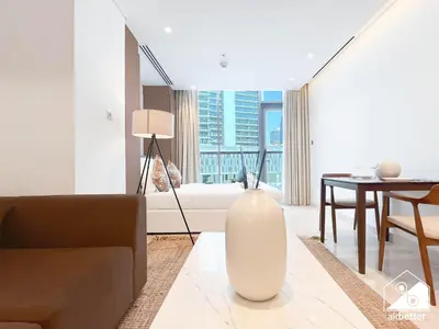 a living room with a large white vase on the floor at Sterling East Prime Location ST in Business Bay in Dubai