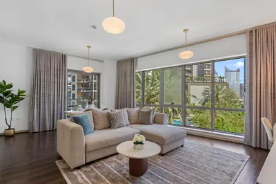a living room with a couch and a large window at Exceptional 1-bedroom with pool view in Downtown in Dubai