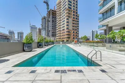 a swimming pool on the roof of a building at Waves - Rustic Chic 1 BR Retreat in Vibrant JVC in Dubai