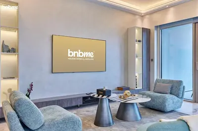 a lobby with two chairs and a table and a picture at bnbme - Luxury Downtown Dubai Apt Burj Khalifa Fountain Views Pool Gym Parking in Dubai