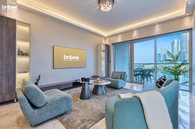 a living room with furniture and a view of the city at bnbme - Luxury Downtown Dubai Apt Burj Khalifa Fountain Views Pool Gym Parking in Dubai