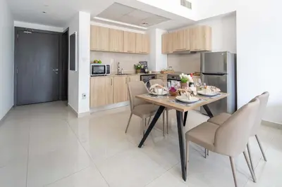 a kitchen and dining room with a table and chairs at Frank Poretr - AG Tower in Dubai