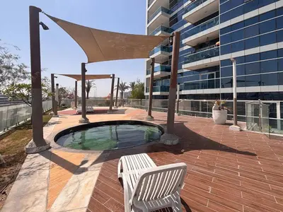 a hot tub in a patio next to a building at Frank Porter - Al Jawhara Tower in Dubai