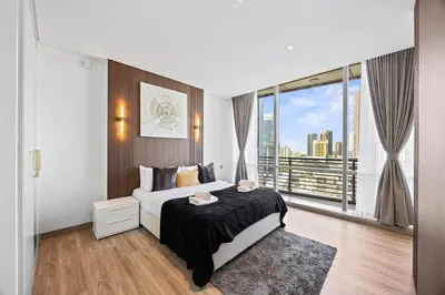 a bedroom with a bed and a large window at YOUR STAY CORPORATE RESIDENCES DIFC Sky Gardens in Dubai