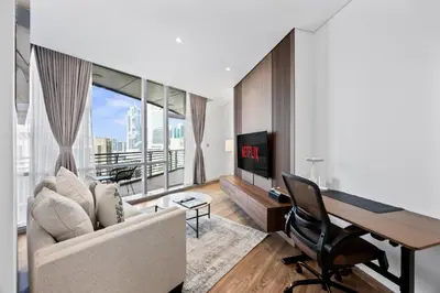 a living room with a couch and a desk and a tv at YOUR STAY CORPORATE RESIDENCES DIFC Sky Gardens in Dubai