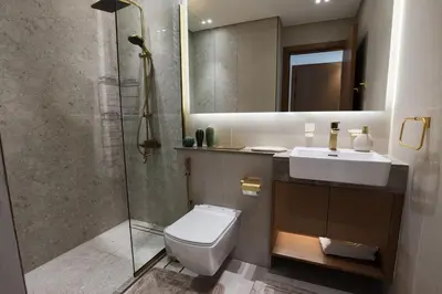 a bathroom with a toilet and a sink and a shower at Gracious 1BR in Binghatti Amber in Dubai