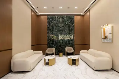 a waiting room with two couches and two tables at Gracious 1BR in Binghatti Amber in Dubai