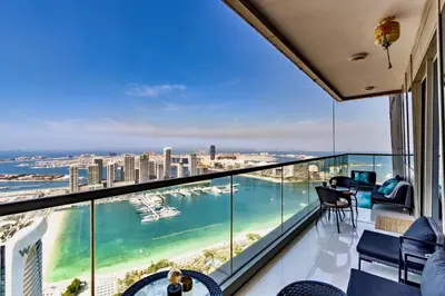 a balcony with a view of the beach and the ocean at Ocean Heights Dubai Marina Ocean View in Dubai