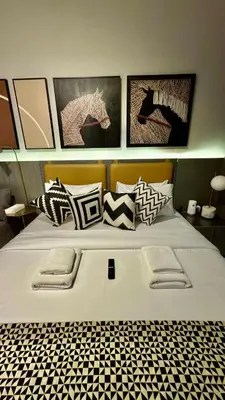 a bedroom with a bed with black and white pillows at Burj Khalifa View 5 Mins Walk to Dubai Mall in Dubai