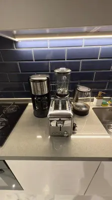 a counter with a blender and other items on it at Burj Khalifa View 5 Mins Walk to Dubai Mall in Dubai