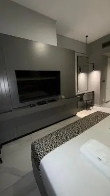 a bedroom with a large flat screen tv and a bed at Burj Khalifa View 5 Mins Walk to Dubai Mall in Dubai