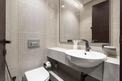 a white bathroom with a sink and a toilet at Luxurious Apt 2BR Stunning Full Burj Khalifa view in Dubai