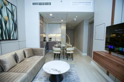 a living room with a couch and a table at Standard 1BHK located in Azizi Riviera 48 in Dubai