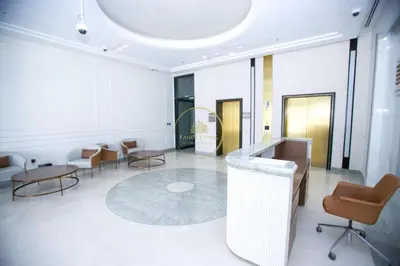 a lobby with chairs and tables and a mirror at Standard 1BHK located in Azizi Riviera 48 in Dubai