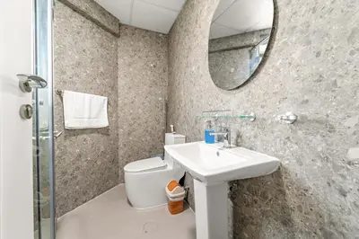 a bathroom with a toilet and a sink and a mirror at Bright Studio in Dubai Gate 2 in Dubai