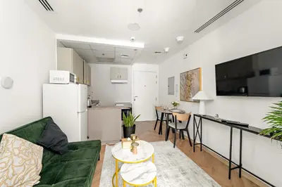 a living room with a couch and a kitchen at Bright Studio in Dubai Gate 2 in Dubai