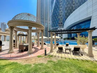 a gazebo with tables and chairs next to a building at Vogue DIFC Damac Park Tower near Museum of The Future, One Bedroom Apartment with Balcony, City Skyline and Museum of The Future View, Access to all Amenities in Dubai