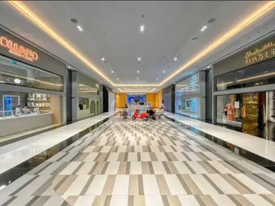 a shopping mall with people sitting in the aisle at Vogue DIFC Damac Park Tower near Museum of The Future, One Bedroom Apartment with Balcony, City Skyline and Museum of The Future View, Access to all Amenities in Dubai