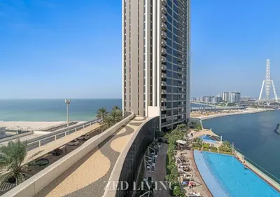 a view of a tall building next to the beach at Emaar 5242 - Stunning Sea View Stay in Prime Waterfront Location - Zed Living in Dubai
