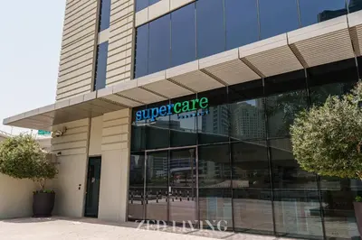 a building with a superporate sign on the front of it at Emaar 5242 - Stunning Sea View Stay in Prime Waterfront Location - Zed Living in Dubai