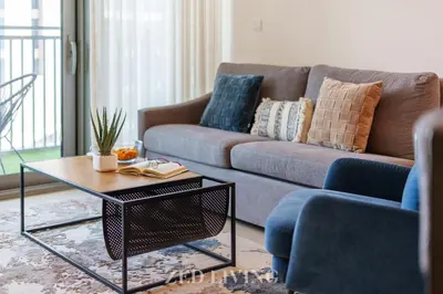 a living room with a couch and a coffee table at Emaar 5242 - Stunning Sea View Stay in Prime Waterfront Location - Zed Living in Dubai