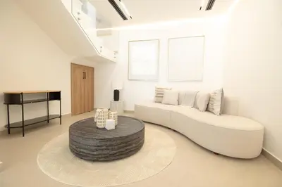 a living room with a white couch and a table at Designer Furnished Villa with Luxury Finishes in Springs 14 in Dubai