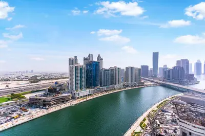 a view of a city with a river and buildings at FAM Living Trillionaire Residences Premium Studio with Private Jacuzzi and Canal View in Dubai
