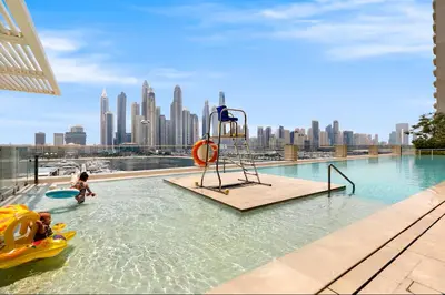 a pool with a playground in the middle of a city at Vogue Emaar Beach Front Marina Vista near JBR and Palm Jumeirah, Two Bedroom Apartment with Balcony and Private Beach, Access to all Amenities in Dubai