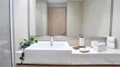 a bathroom with a white sink and a mirror at New Modern Japanese Style Studio by Downtown in Dubai