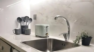 a kitchen counter with a sink and a mixer at New Modern Japanese Style Studio by Downtown in Dubai