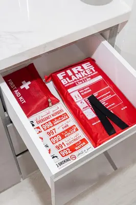 a white drawer filled with red and white boxes at New Modern Japanese Style Studio by Downtown in Dubai